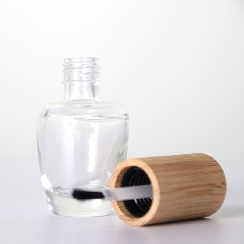 Botella de esmalte de uñas de vidrio vacía transparente con tapa de bambú