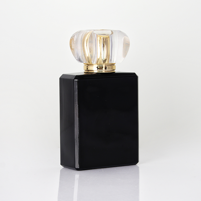 Elegante botella de perfume de vidrio en aerosol de colonia negra y dorada